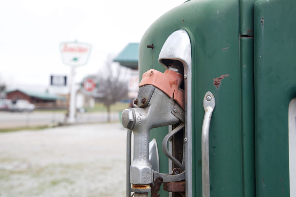 a close up of a fuel nozzle on a green truck