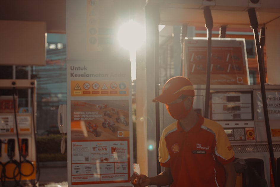 man in red and white adidas crew neck t-shirt wearing orange cap
