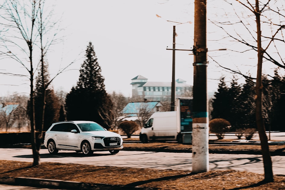 a white car is parked in a parking lot
