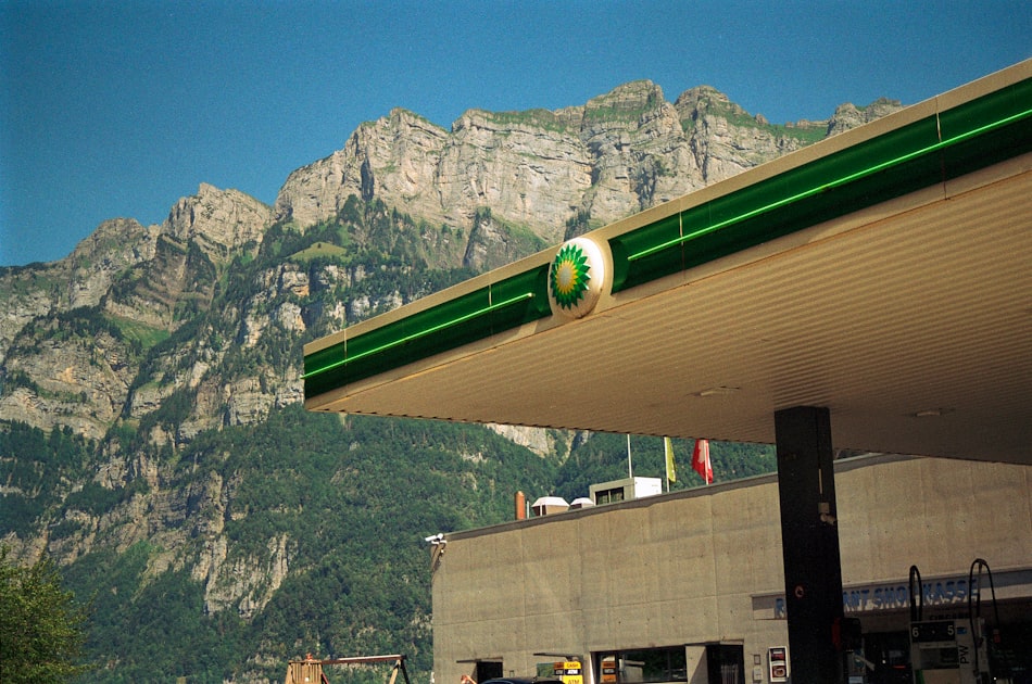 a gas station with mountains in the background